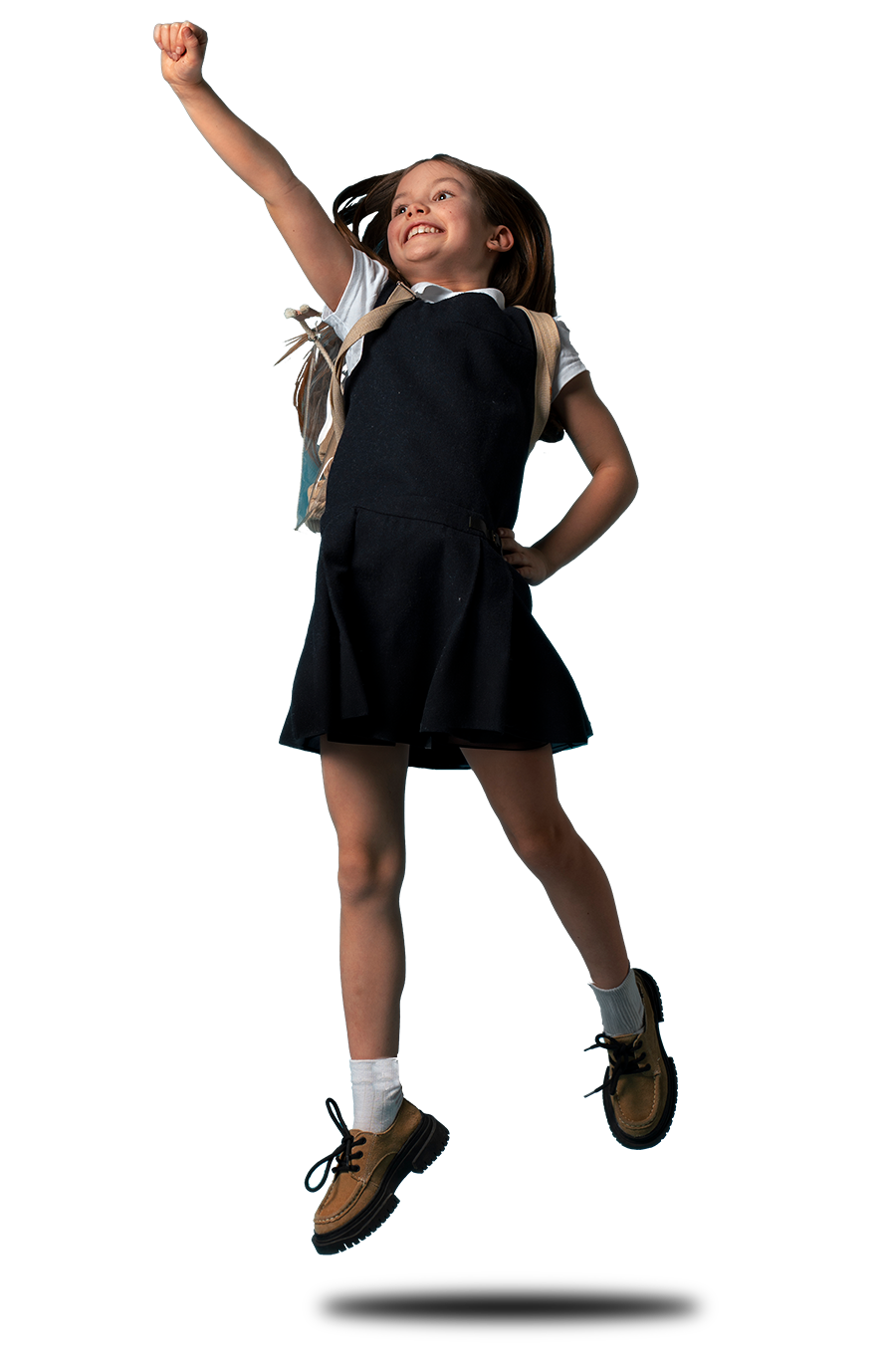 Schoolgirl jumping in the air doing a superman pose